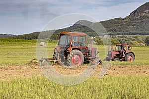 Old tractor working on the field