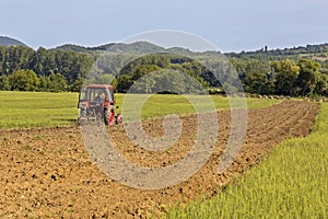 Old tractor working on the field