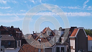 Old traditional Dutch city rooftops on a clear blue sky