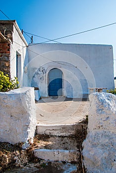 An old traditional house with a blue door in Antikythera island in Greece.