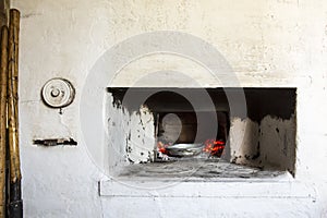 Old Russian village stove. Nearby are the tools tongs, shovel to get dishes from the hot oven with coals