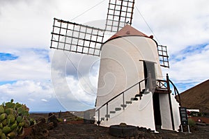 Old traditional spanish windmill in Jardin de cactus , Lanzarote Spain photo