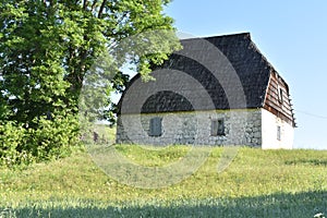 The old,traditional stone house with the shingle roof