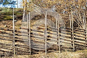 Old traditional swedish wooden fence. Vintage style hedge. Countryside authentic cozy hand made wooden fence