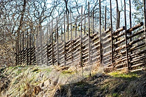 Old traditional swedish wooden fence. Vintage style hedge. Countryside authentic cozy hand made wooden fence palisade in a rural a