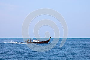 Old traditional Thai motorboat made of wood for fishing and transporting tourists on excursions in the Andaman Sea in clear