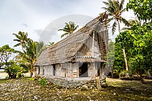 Old traditional thatched yapese men`s meeting house faluw or fale. Yap island, Federated States of Micronesia, Oceania. photo