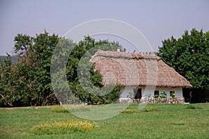 Old traditional ukrainian rural cottage with a straw roof