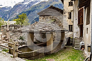 Old traditional washing house in open air in the mountain village Soglio