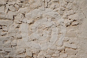 Old traditional whitewashed stone wall texture