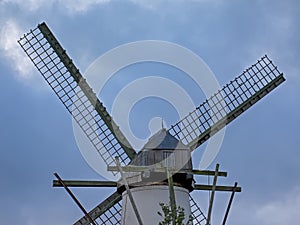 Detail of an old windmill on a cloudy sky photo
