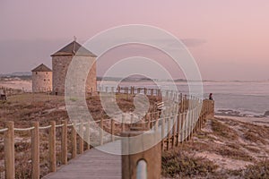 Old traditional wind-mills in sand-hills of Apulia Portugal.