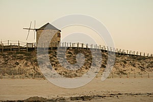 Old traditional wind-mills in sand-hills of Apulia Portugal