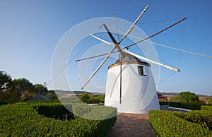 Old traditional windmill on the hill near El Granado in Andalusia, Spain photo