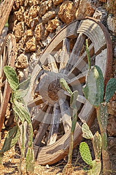The old traditional wooden wheels on stone wall background