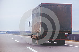 Old trailer truck in motion on freeway