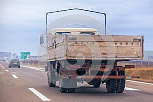 Old trailer truck in motion on freeway