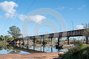 Old train bridge in Arroyo Solis Chico in Parque del Plata on the Gold Coast in Uruguay photo