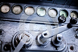 Old train dashboard with clogged goggles and control levers photo