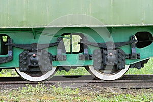 Old train and locomotive. Railroad tracks stretches and green grass and trees. Railway road environment background.