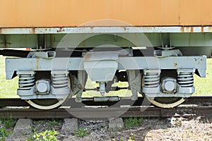 Old train and locomotive. Railroad tracks stretches and green grass and trees. Railway road environment background.