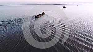 Old train rides on the railway laid in the water through the salt lake. train travels from water. Mined salt in Lake Burlin. Altai