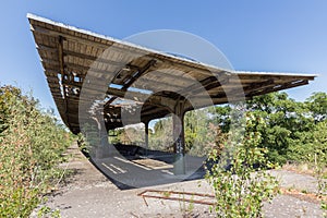 Old train station, abandoned and overgrown - outdoor with destroyed roof
