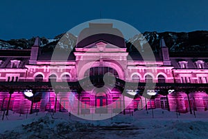 Old train station of Canfranc with the facade illuminated on a winter night with snow on the tracks, Huesca, Spain