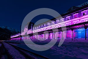 Old train station of Canfranc on a winter night with snow on the tracks, Huesca, Spain
