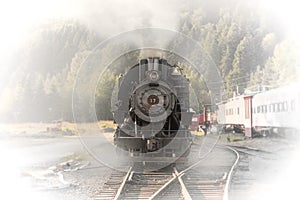 Old train steam engine with steam released