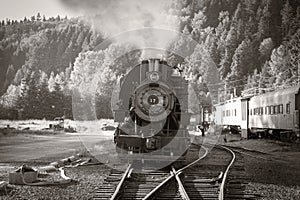 Old train steam engine with steam released
