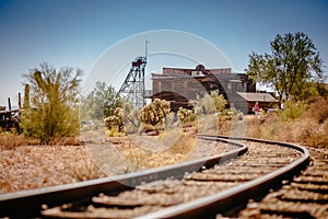 Old Train tracks in Goldfield Gold Mine Ghost Town in Youngsberg, Arizona, USA surrounded by desert