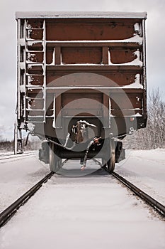 Old train wagon on track in winter