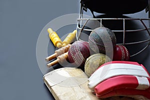 Leather cricket ball, wickets, helmet, gloves and wooden bat