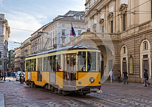 Old tram passing at La Scala theatre in Milan