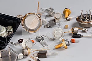 Old transistors various purpose in different packages on gray surface