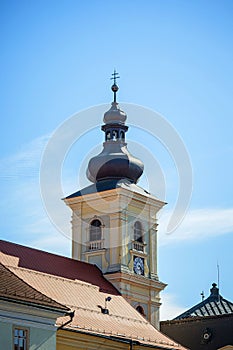 Old transylvanian church tower with cross and clock