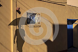 Old Trinidat.Shadow of a man with umbrella