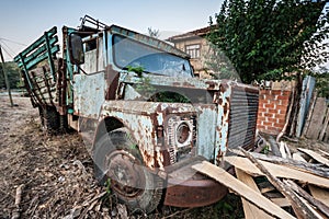 Old Truck Abandoned in front of a Village Backyard Wall