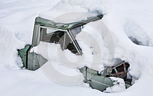 Old truck buried in snow