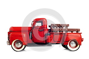 Old truck close-up. Red, vintage, toy truck isolated on white background