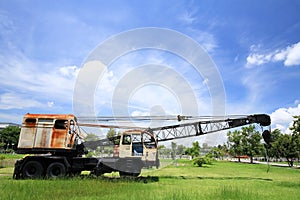 Old truck with digger againt blue sky