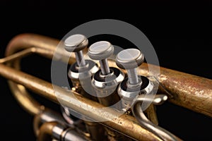 Old trumpet on a dark wooden table. Wind instrument in the old style