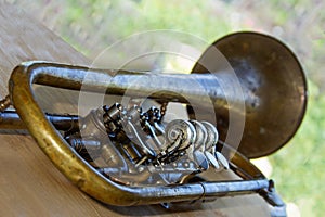 Old trumpet - wind musical instrument. Shallow depth of field. Background is blurred