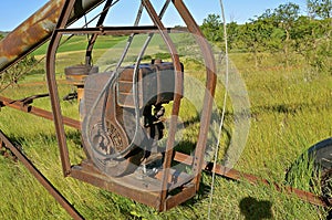 Old tube grain elevator powered by gas engine