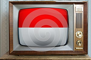 Old tube vintage TV with the national flag of Monaco, Nuremberg, Indonesia on the screen, the concept of eternal values â€‹â€‹on