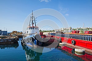 Old tugboat and barges at Piraeus