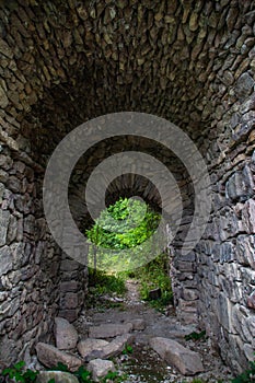 The old tunnel leads to the forest. Tunnel and stone arch