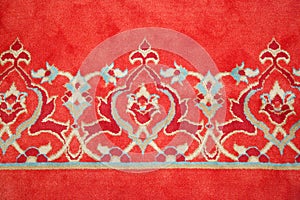 Old Turkish red carpet with geometric and floral decorations