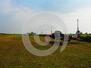 An old turprop aircraft is parking in the field